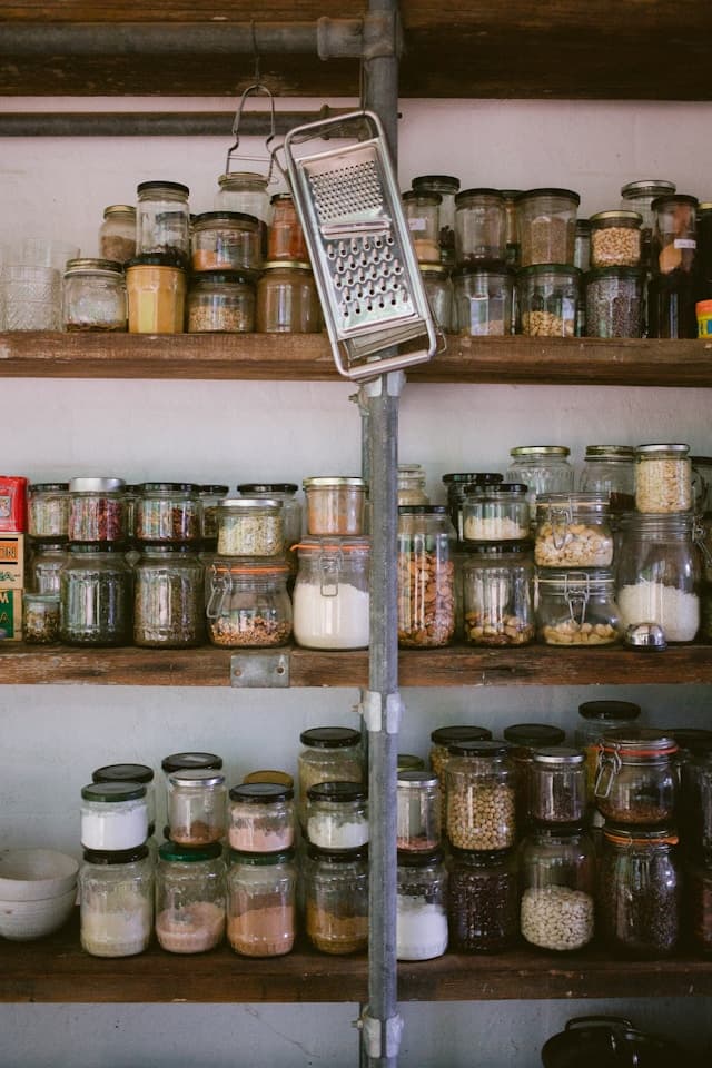 Pantry shelves stocked with fresh bread, veg and jars